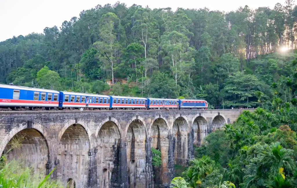 Blue train crossing the 9-Arches bridge, Ella. Sri Lanka. Photo: Harmeet Sehgal