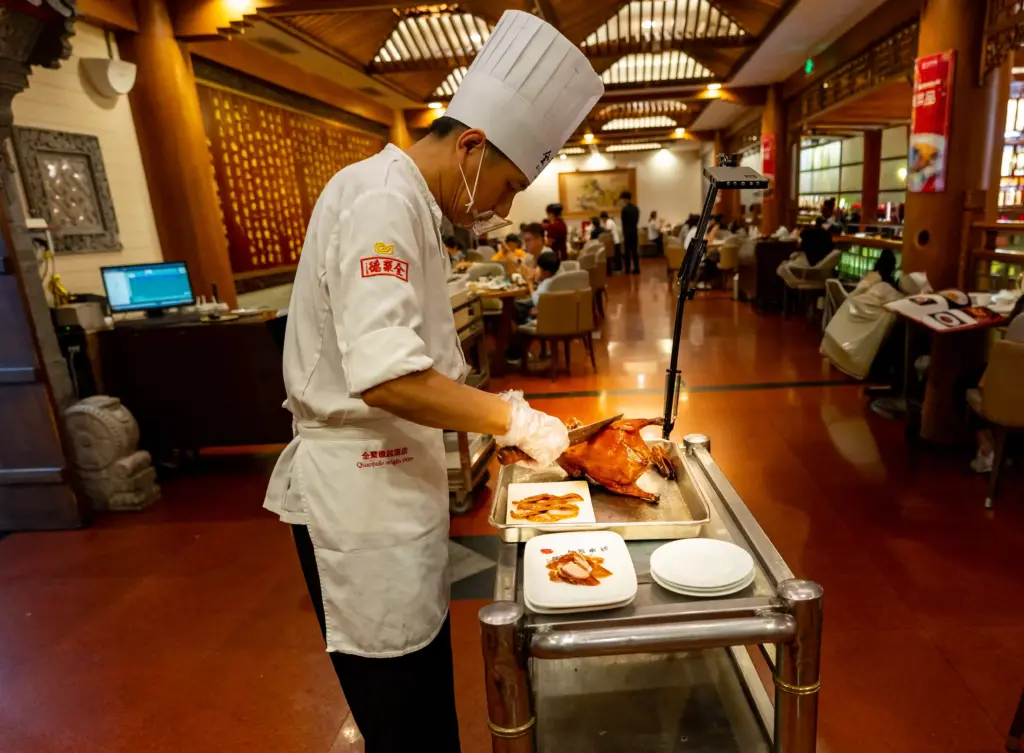 Carving traditional Peking Duck at the table. Photo: Harmeet Sehgal